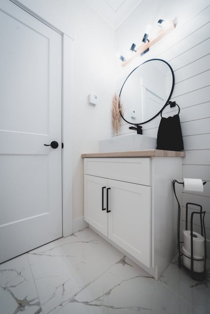 Interior of modern white bathroom with mirror and sink