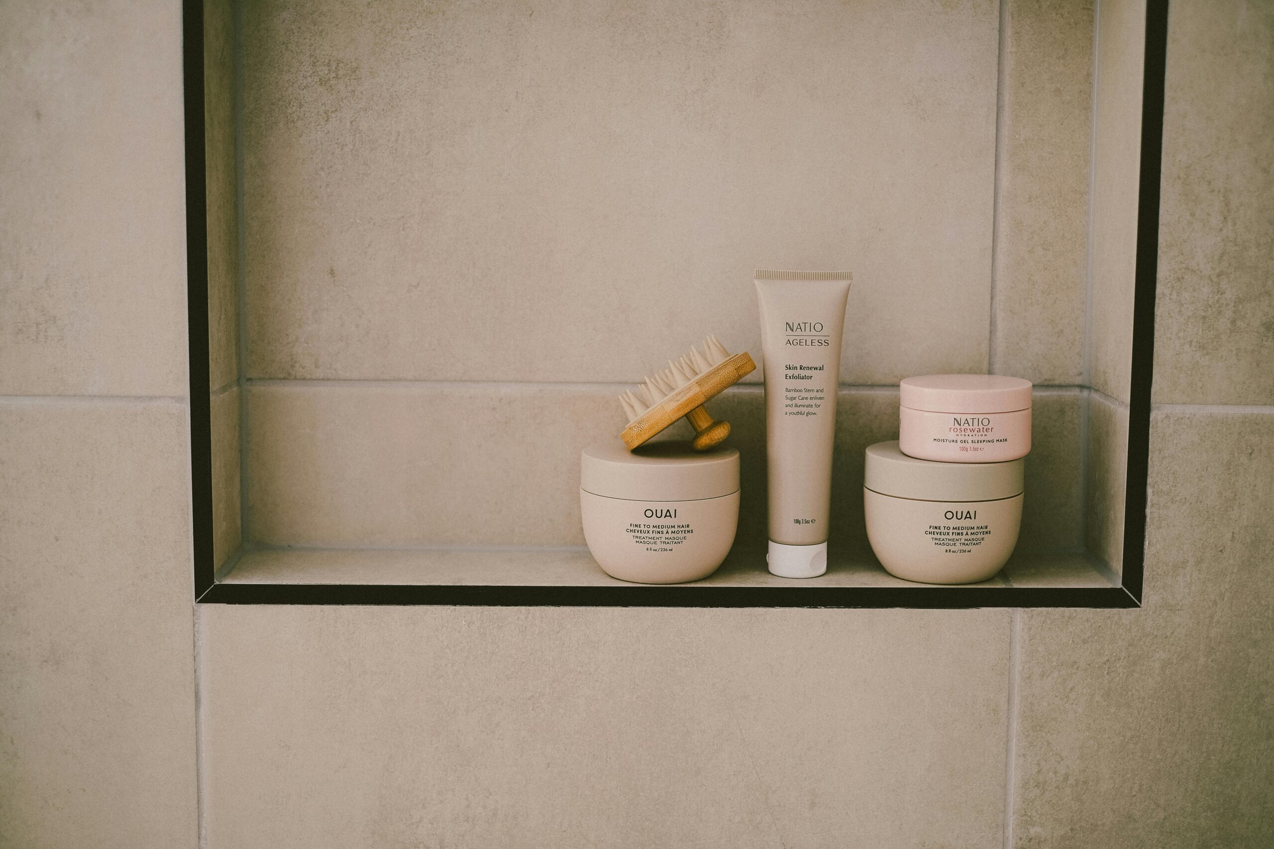 Explore a modern minimalist bathroom shelf with beauty products and hair care essentials in neutral tones.